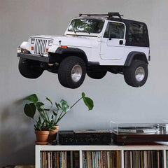 36 inch white Jeep decal installed on a wall above a shelf with records and plants